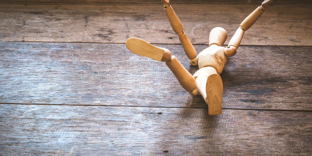 Wooden figure fallen on the ground